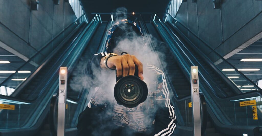 Person holding a camera in a smoke-filled urban setting with escalators.